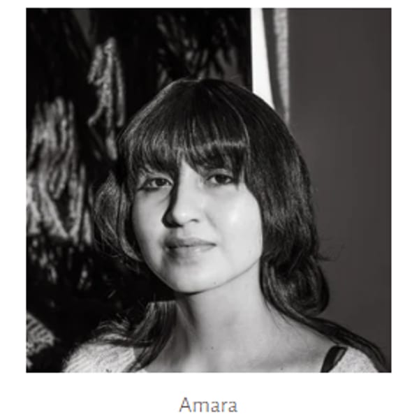 Black and white portrait of Amara, a woman with dark hair and bangs, looking forward.